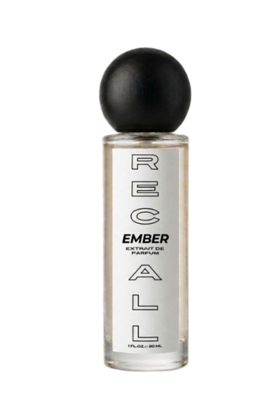 A clear glass bottle of RECALL fragrance with a black spherical cap, featuring vertical black text on the bottle, set against a solid white background.