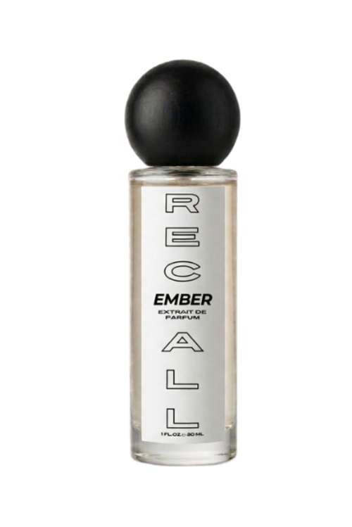 A clear glass bottle of RECALL fragrance with a black spherical cap, featuring vertical black text on the bottle, set against a solid white background.